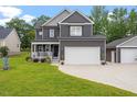 Stylish two-story home featuring a spacious two-car garage, complemented by a lush green lawn at 852 Cokesbury Park Lane Ln, Fuquay Varina, NC 27526