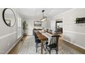 Elegant dining room with hardwood floors, modern lighting, and decorative accents at 9212 Sayornis Ct, Raleigh, NC 27615
