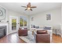 Bright living room featuring a fireplace, hardwood floors, and a door leading to the deck at 100 Stratford Lakes # 130, Durham, NC 27713