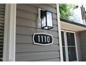 Close-up of house number 1110 with modern lighting fixture at 1110 Elmira Ave, Durham, NC 27707