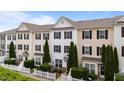Townhouse exteriors showcasing varied siding colors, black shutters and tidy landscaping at 1120 Renewal Pl # 111, Raleigh, NC 27603