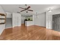 Open living space with hardwood flooring, ceiling fan and access to the kitchen and staircase at 1120 Renewal Pl # 111, Raleigh, NC 27603