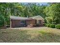 Brick home featuring well-maintained lawn and mature trees at 1134 Deerfoot Trail Trl, Sanford, NC 27332