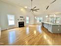 Spacious living room featuring a fireplace, large windows, and hardwood floors at 121 Chimney Rise Dr, Cary, NC 27511