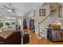 Spacious living room with hardwood floors, staircase and plenty of natural light at 12221 Orchardgrass Ln, Raleigh, NC 27614