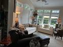 Bright living room with large windows and comfortable seating at 12221 Orchardgrass Ln, Raleigh, NC 27614