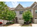 Traditional townhouse with attached garage and mature trees in front yard at 127 Bowerbank Ln, Apex, NC 27539