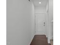 Bright, freshly-painted foyer with wood floors and white door at 127 Bowerbank Ln, Apex, NC 27539