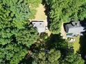 Aerial view of a house surrounded by lush greenery showing a tree-filled landscape at 129 Clark Ct, Youngsville, NC 27596