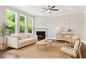 Inviting living room with hardwood floors, neutral decor, and a cozy fireplace at 1600 Drift Falls Ln, Wendell, NC 27591