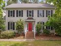 Charming two-story home with black shutters and a red front door at 18 Acornridge Ct, Durham, NC 27707