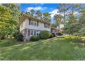 Angle shot of house with light colored stucco siding and green grass at 1920 Hillock Dr, Raleigh, NC 27612