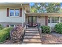 Home's brick front entrance and decorative plants are inviting at 1920 Hillock Dr, Raleigh, NC 27612