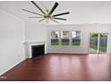 Bright, spacious living room with a fireplace, a large ceiling fan and a sliding glass door at 2072 Tanners Mill Dr, Durham, NC 27703