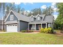Charming home featuring a two-car garage, well-maintained lawn, and covered front porch at 210 Sorrel Dr, Franklinton, NC 27525
