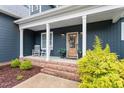 Covered porch features inviting rocking chairs and decorative landscaping at 210 Sorrel Dr, Franklinton, NC 27525