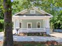 Charming exterior featuring a cozy porch with white columns and craftsman style details at 2106 University Dr, Durham, NC 27707
