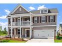 Elegant two-story home with a covered porch, two-car garage, and neutral color palette at 2178 Pink Peony Circle Lot 167 Cir, Durham, NC 27703