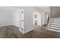 Bright, open floor plan featuring hardwood floors, white trim, and an arched doorway at 2178 Pink Peony Circle Lot 167 Cir, Durham, NC 27703