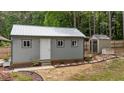 Well-maintained outbuilding featuring a metal roof, providing functional and aesthetically pleasing outdoor storage at 225 Sacred Fire Rd, Louisburg, NC 27549