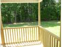 View from the home's covered back porch and lush green yard at 235 Eason Creek Way, Clayton, NC 27527