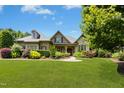 Charming home featuring lush lawn, colorful landscaping and a brick and stone facade at 238 Michelangelo Way, Cary, NC 27518