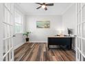 Bright office featuring wood floors, ceiling fan, desk, and French doors at 279 Edge Of Auburn Blvd, Raleigh, NC 27610