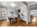 Bright dining room with hardwood floors, stylish decor, and seamless kitchen access at 282 Granite Mill Blvd, Chapel Hill, NC 27516