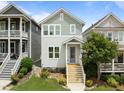 Charming two-story home with light-green and gray siding, complemented by a well-manicured lawn and inviting front porch at 282 Granite Mill Blvd, Chapel Hill, NC 27516