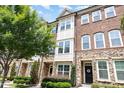 A charming brick and stone townhome with well-maintained landscaping at 3109 Stockdale Dr, Raleigh, NC 27609