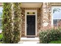 A close-up of the front door with stone surround and landscaping at 3109 Stockdale Dr, Raleigh, NC 27609