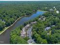 Scenic aerial view of the property nestled along a tranquil lake and lush greenery at 313 Glen Echo Ln # J, Cary, NC 27518