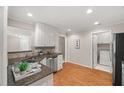 Fully equipped kitchen with stainless appliances, and a separate laundry area at 313 Glen Echo Ln # J, Cary, NC 27518