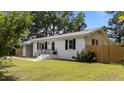 Traditional-style home with black shutters, a well-manicured lawn, and convenient carport at 314 Wrenn St, Apex, NC 27502