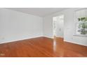 Bright living room featuring hardwood floors, neutral walls, and ample natural light at 3141 Rapid Falls Rd, Cary, NC 27519
