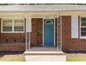 Close-up of the front entrance featuring a light blue door and decorative white iron columns at 408 N Stewart St, Clayton, NC 27520