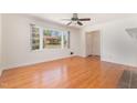 Bright and spacious living room with hardwood floors, a large window, and a ceiling fan at 408 N Stewart St, Clayton, NC 27520