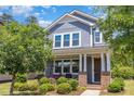 Charming two-story home with a cozy front porch swing and beautiful landscaping at 425 Liberty Hill, Morrisville, NC 27560