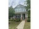 Charming two-story home with blue siding, brick accents, and a welcoming front porch at 425 Liberty Hill, Morrisville, NC 27560