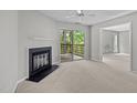 Cozy living room with a fireplace and sliding glass doors to the outside deck at 4631 Timbermill Ct # 203, Raleigh, NC 27612