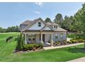 Beautiful home with manicured lawn, attractive landscaping, and a welcoming covered porch at 475 Long View Dr, Franklinton, NC 27525