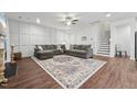 Spacious living room featuring hardwood floors, a cozy sectional, and a decorative accent wall at 475 Long View Dr, Franklinton, NC 27525