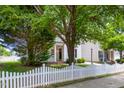 Charming two-story home with white siding, black shutters, and a well-manicured front yard and a white picket fence at 5016 Dawn Piper Dr, Raleigh, NC 27613