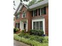 Charming brick home featuring an arched window, mature landscaping, and black shutters at 511 Windstream Way, Cary, NC 27518