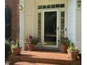 Inviting front porch with potted plants creating a warm and welcoming entrance at 511 Windstream Way, Cary, NC 27518