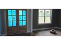 Entryway view with wood-look floors, blue painter's tape, a window, and unfinished french doors at 55 Livingston Ln, Spring Hope, NC 27882