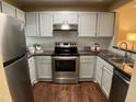 Well-lit kitchen with stainless steel appliances, subway tile backsplash, and ample countertop space at 600 Audobon Lake Dr # One B21, Durham, NC 27713