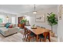 Open concept dining area with modern furniture and natural light at 6032 Epping Forest Dr, Raleigh, NC 27613