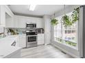 Bright kitchen with white cabinets and stainless steel appliances at 6032 Epping Forest Dr, Raleigh, NC 27613