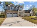 Charming two-story home with stone accents, a welcoming front porch, and a two-car garage at 604 Craftsman Ridge Trail Trl, Knightdale, NC 27545